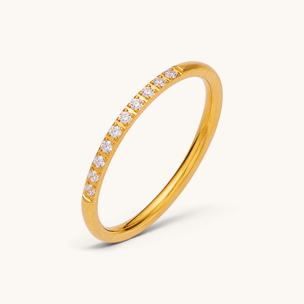 Nadare Co. Evie Ring featuring a delicate gold stainless steel band with a row of sparkling clear cubic zirconia.