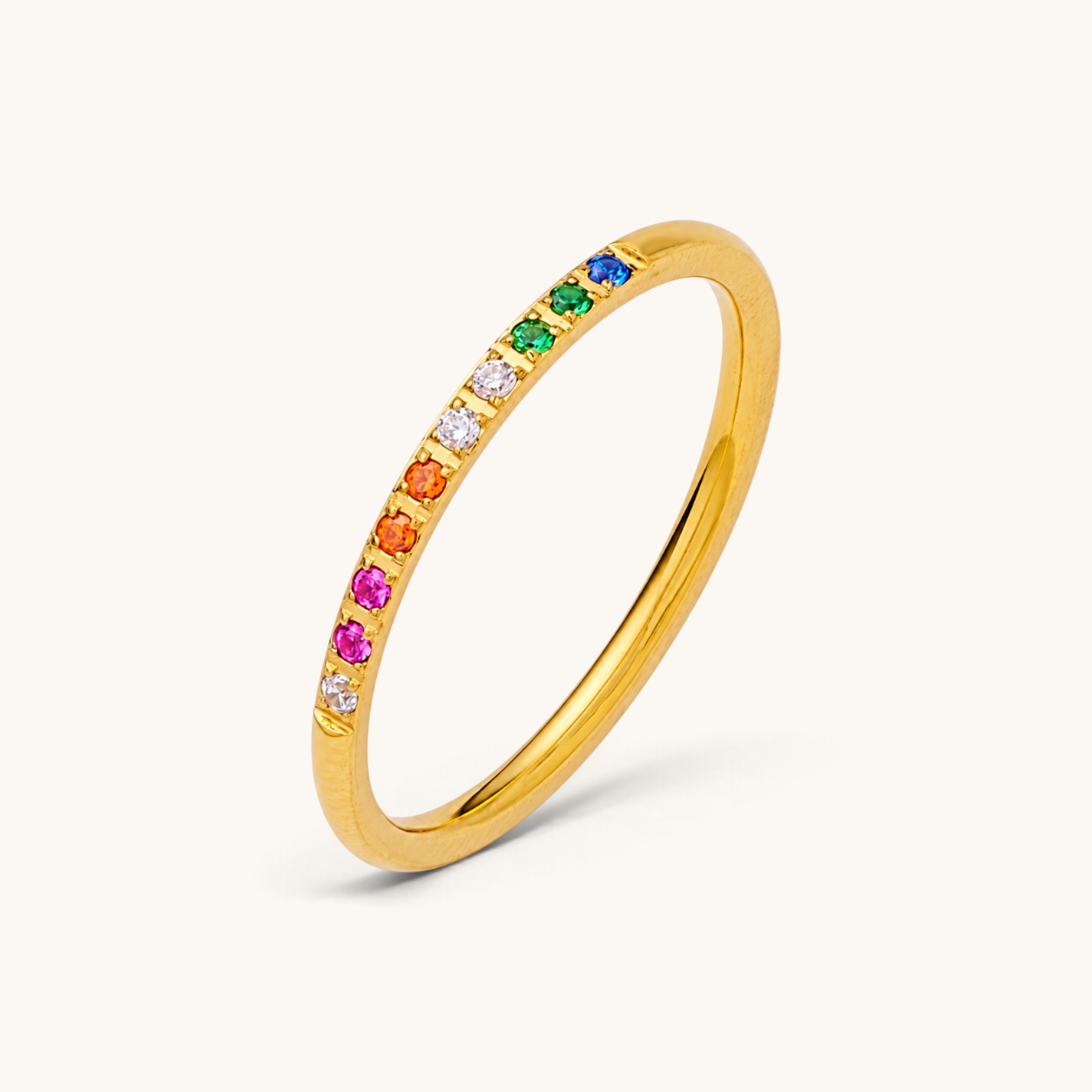 Nadare Co. Evie Ring in gold stainless steel with a delicate band featuring rainbow cubic zirconia stones.