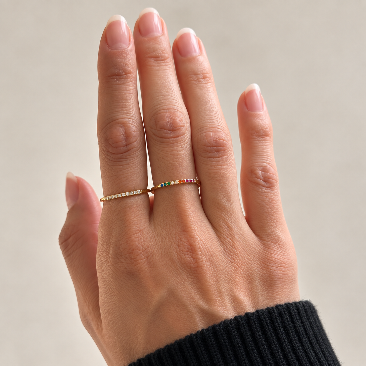 Nadare Co. Evie Ring set featuring delicate gold stainless steel bands with clear and rainbow cubic zirconia stones