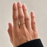 Nadare Co. Evie Ring set featuring delicate gold stainless steel bands with clear and rainbow cubic zirconia stones