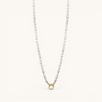 Nadare Co. freshwater pearl necklace with a gold-toned circular clasp featuring small embedded crystals.
