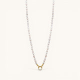 Nadare Co. freshwater pearl necklace with a gold-toned circular clasp featuring small embedded crystals.