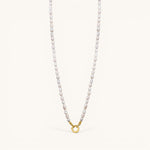 Nadare Co. freshwater pearl necklace featuring unique organic pearls and a gold-toned circular clasp.