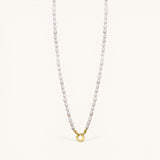 Nadare Co. freshwater pearl necklace featuring unique organic pearls and a gold-toned circular clasp.
