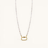 Nadare Co. freshwater pearl chain necklace with a gold-tone oval clasp charm connector on a cream background.