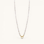 Nadare Co. freshwater pearl necklace with a gold-toned circular clasp featuring small sparkling crystals.
