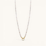 Nadare Co. freshwater pearl necklace with a gold-toned circular clasp featuring small sparkling crystals.