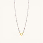 Nadare Co. freshwater pearl necklace featuring unique white pearls and a gold heart-shaped clasp charm.