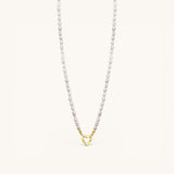 Nadare Co. freshwater pearl necklace featuring unique white pearls and a gold heart-shaped clasp charm.