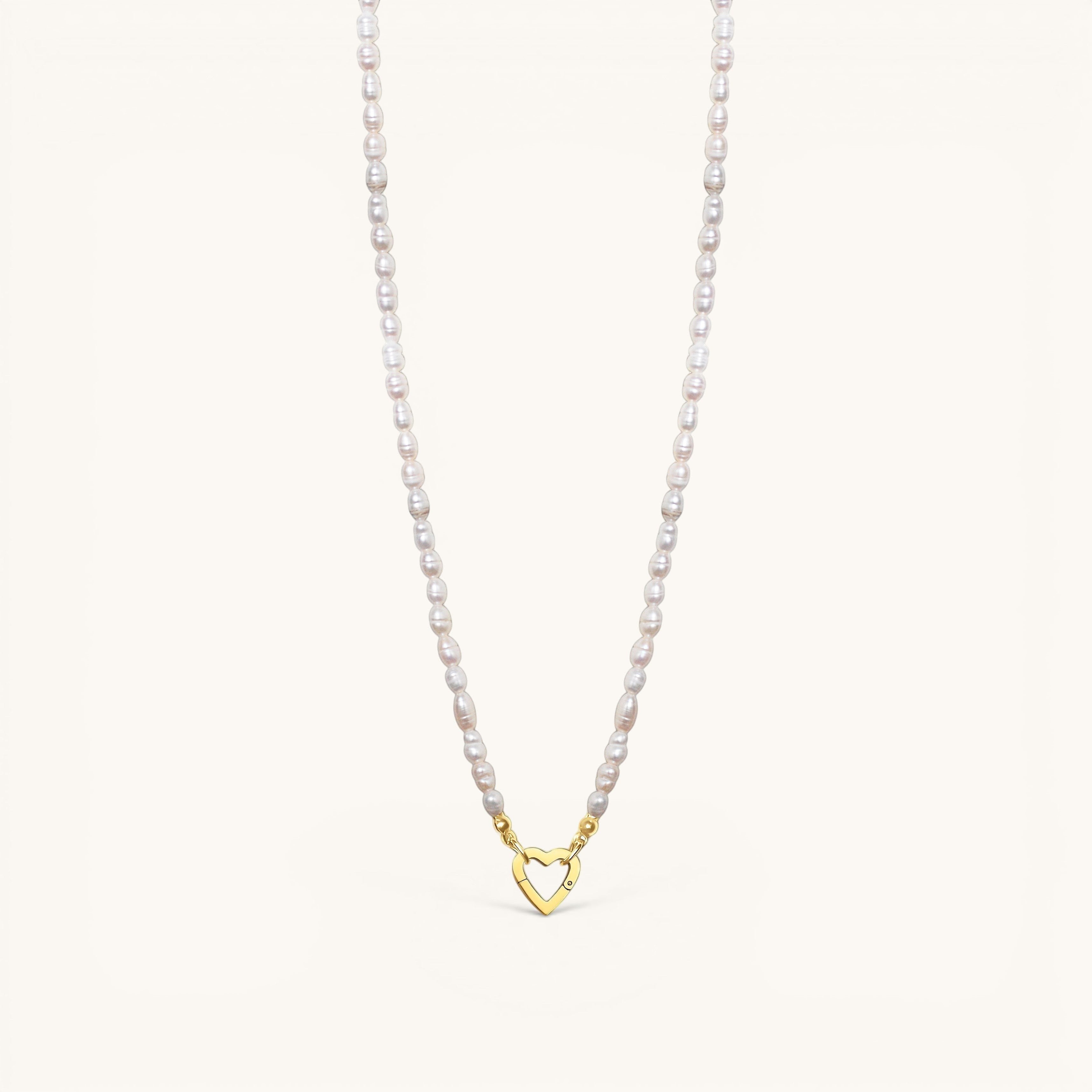 Nadare Co. freshwater pearl necklace featuring unique white pearls and a gold heart-shaped clasp charm.
