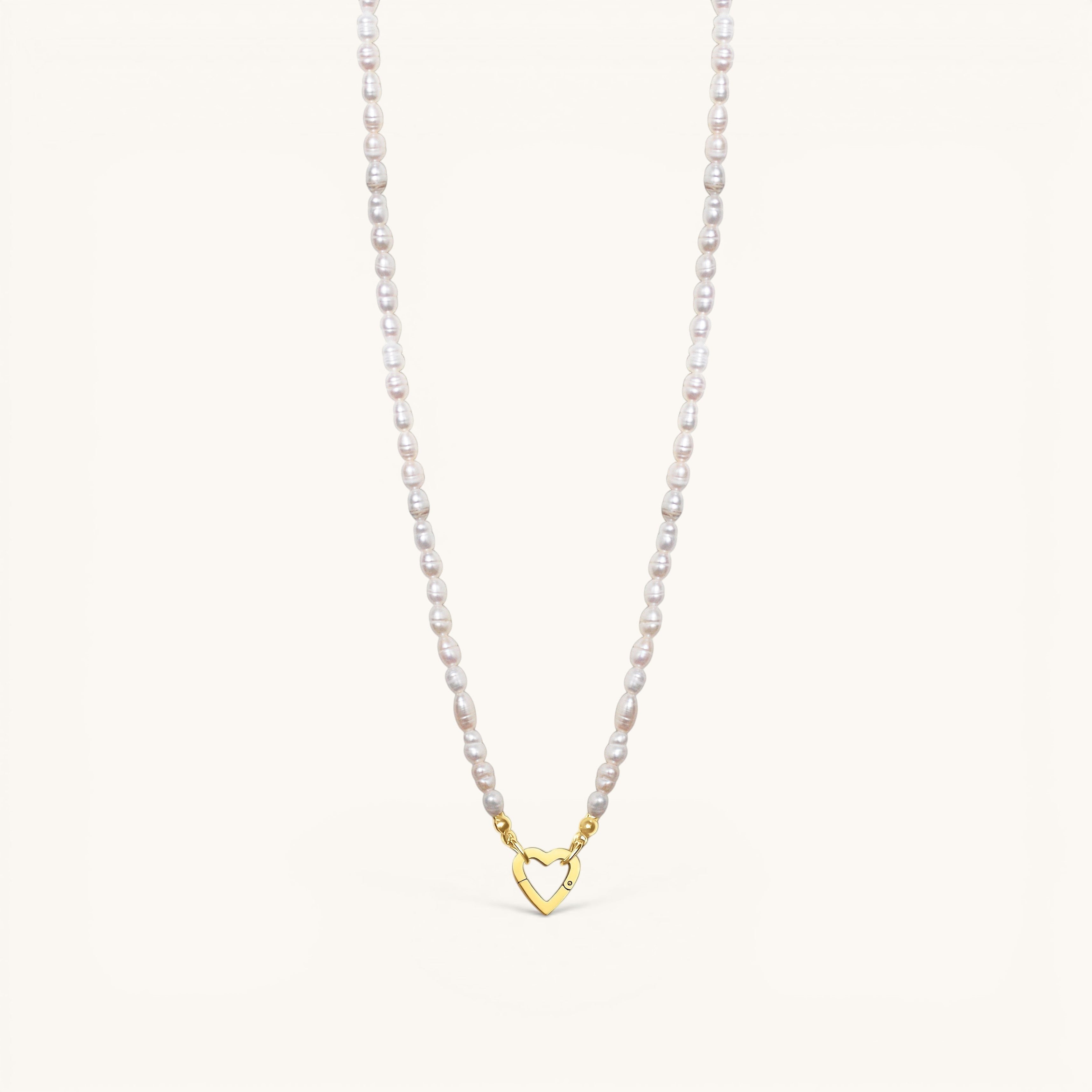 Nadare Co. freshwater pearl necklace featuring a gold heart-shaped clasp from the Switch Charm Collection.