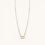Nadare Co. freshwater pearl necklace with a gold-tone oval clasp charm connector on a cream background.