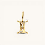 Nadare Co. Gemini zodiac charm in 14k gold-plated stainless steel with sparkling cubic zirconia accents.