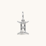Nadare Co. silver Gemini zodiac charm featuring three small cubic zirconia stones on a stainless steel pendant.
