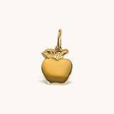 Nadare Co. polished gold apple charm with sculptural stem and leaf detail for necklaces or charm bracelets.