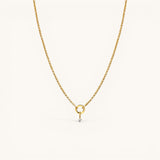 Nadare Co. gold chain necklace featuring a delicate mini birthstone charm on a small circular pendant link.