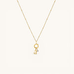 Nadare Co. gold-plated stainless steel necklace featuring a delicate chain and a mini birthstone charm with a letter.