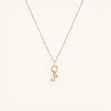 Nadare Co. gold-plated stainless steel necklace featuring a delicate chain and a mini birthstone charm with a letter.