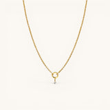 Nadare Co. gold-plated stainless steel necklace featuring a delicate mini cubic zirconia birthstone charm.