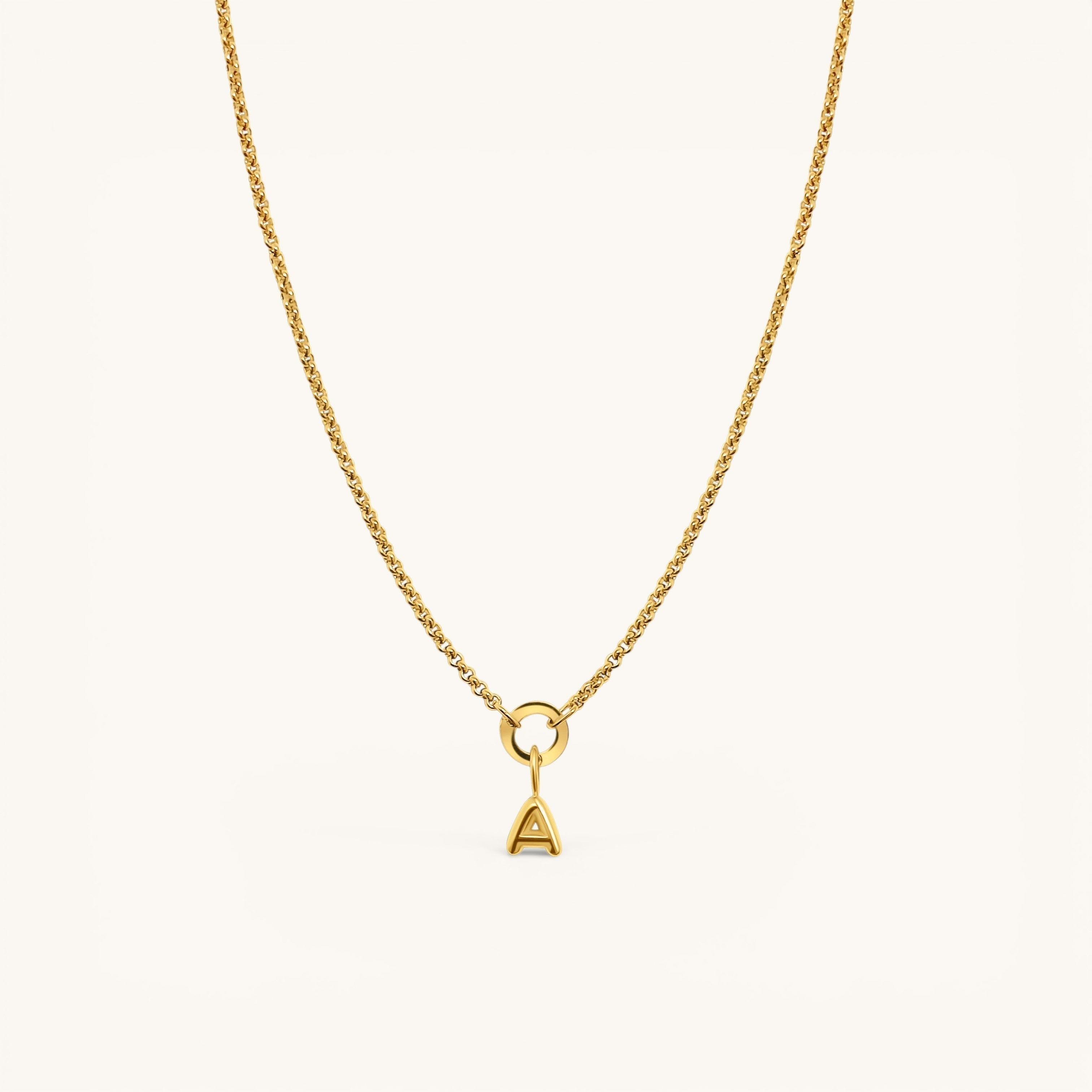 Nadare Co. gold-plated stainless steel bubble initial charm pendant on a delicate chain necklace