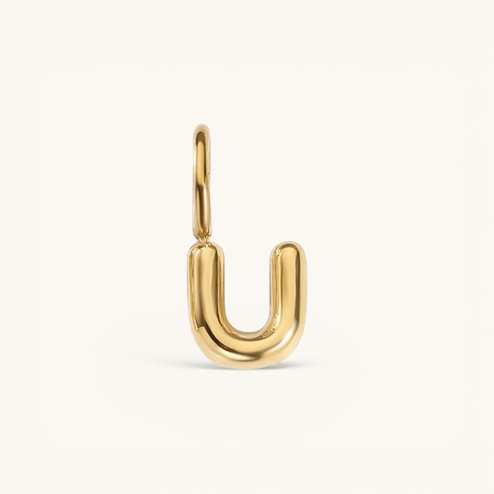 Nadare Co. gold-plated stainless steel bubble initial charm in the shape of the letter U with a rounded puffed design.