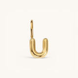 Nadare Co. gold-plated stainless steel bubble initial charm in the shape of the letter U with a rounded puffed design.