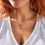 Nadare Co. Cherry Charm necklace featuring a gold-plated cherry pendant on a delicate chain worn by a woman.