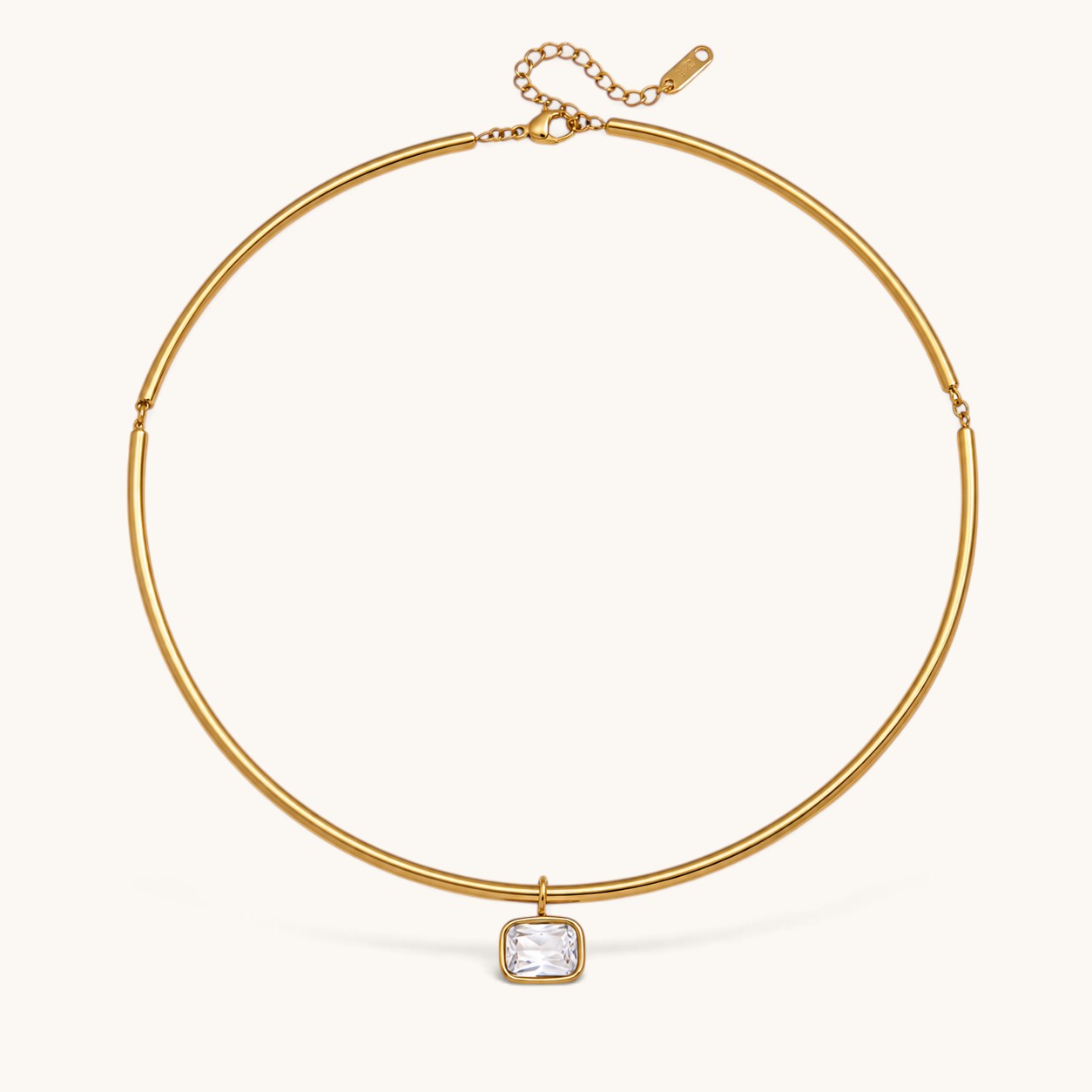 Nadare Co. Margot gold collar necklace with a polished chain and a single bezel-set rectangular crystal pendant.