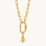 Nadare Co. gold conch shell charm pendant on a thick polished chain link necklace