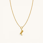 Nadare Co. gold necklace featuring a detailed cowboy boot charm on a delicate chain against a cream background.