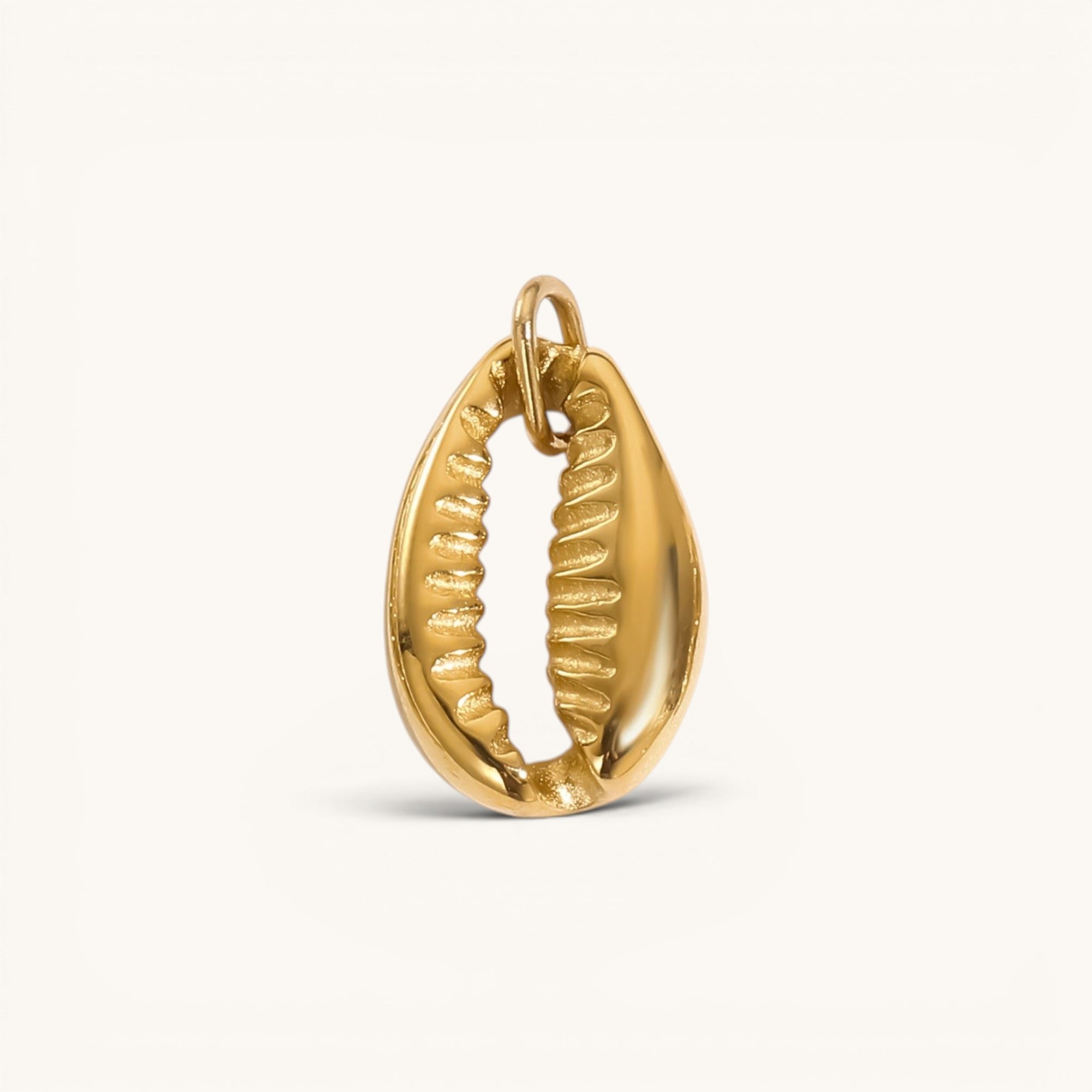 Nadare Co. gold-plated stainless steel cowrie shell charm for a coastal-inspired necklace stack.