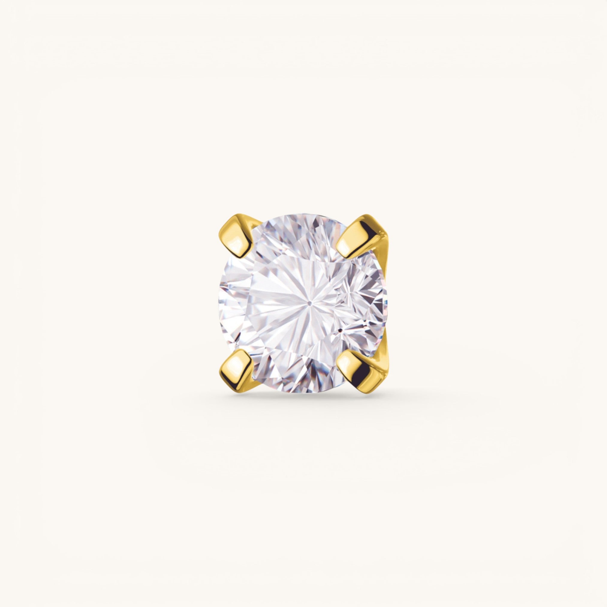 Nadare Co. threadless piercing front featuring a round-cut cubic zirconia in a gold-plated titanium four-prong setting.