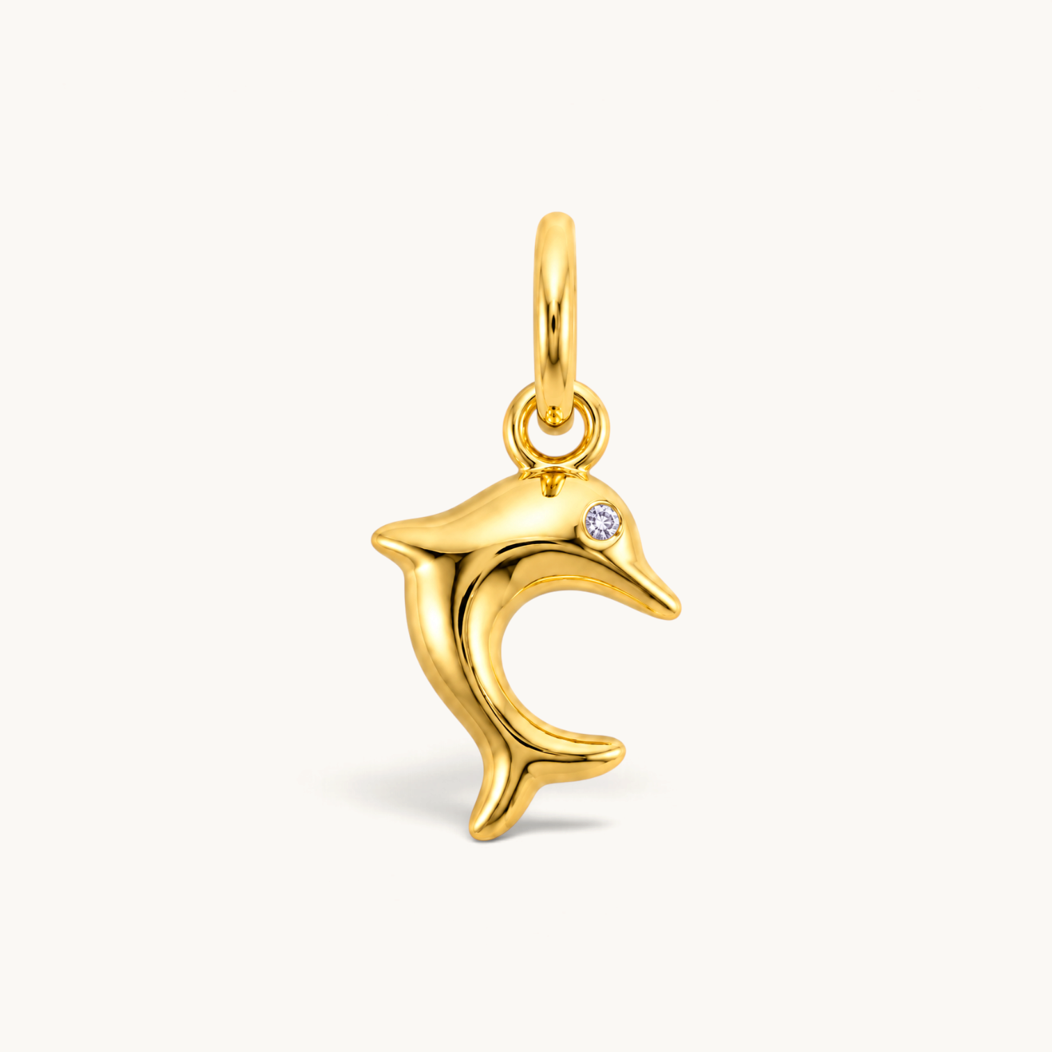 Nadare Co. gold-plated stainless steel dolphin charm with a sparkling cubic zirconia eye in a leaping silhouette.