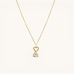 Nadare Co. gold gothic initial charm on a delicate beaded chain with a heart clasp and a small baguette crystal