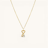 Nadare Co. gold gothic initial charm on a delicate beaded chain with a heart clasp and a small baguette crystal