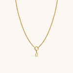 Nadare Co. gold gothic initial charm on a delicate chain necklace, crafted from 14k gold plated stainless steel.