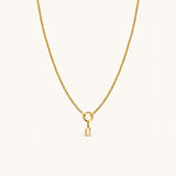 Nadare Co. gold gothic initial charm on a delicate chain necklace, crafted from 14k gold plated stainless steel.