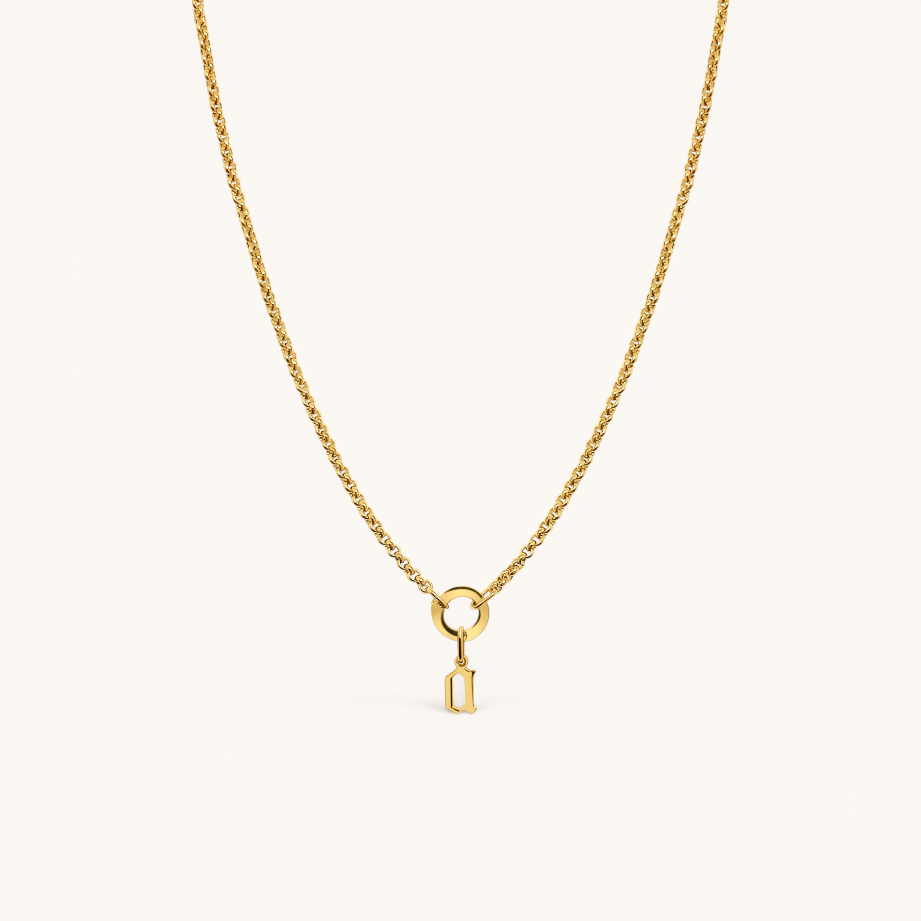 Nadare Co. gold gothic initial charm on a delicate chain necklace, crafted from 14k gold plated stainless steel.