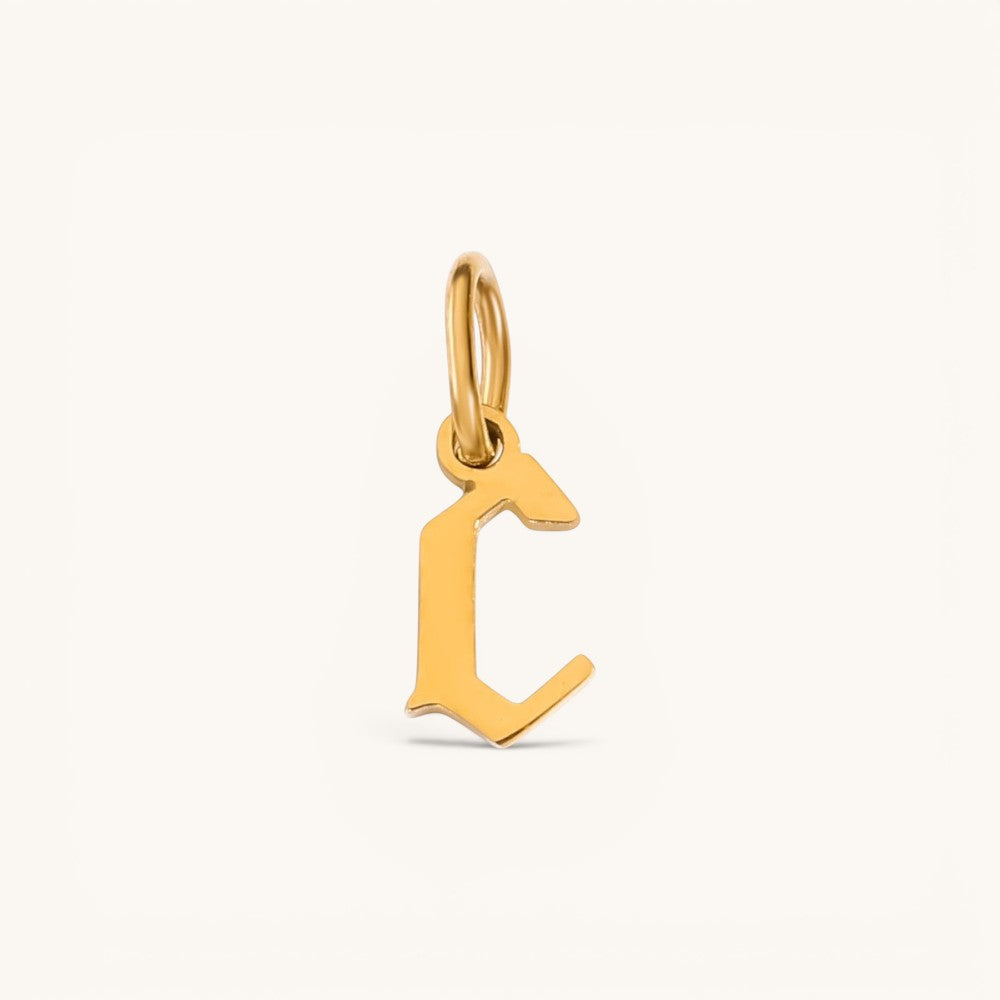 Nadare Co. gold-plated stainless steel gothic letter C charm with sharp edges and old-English style.
