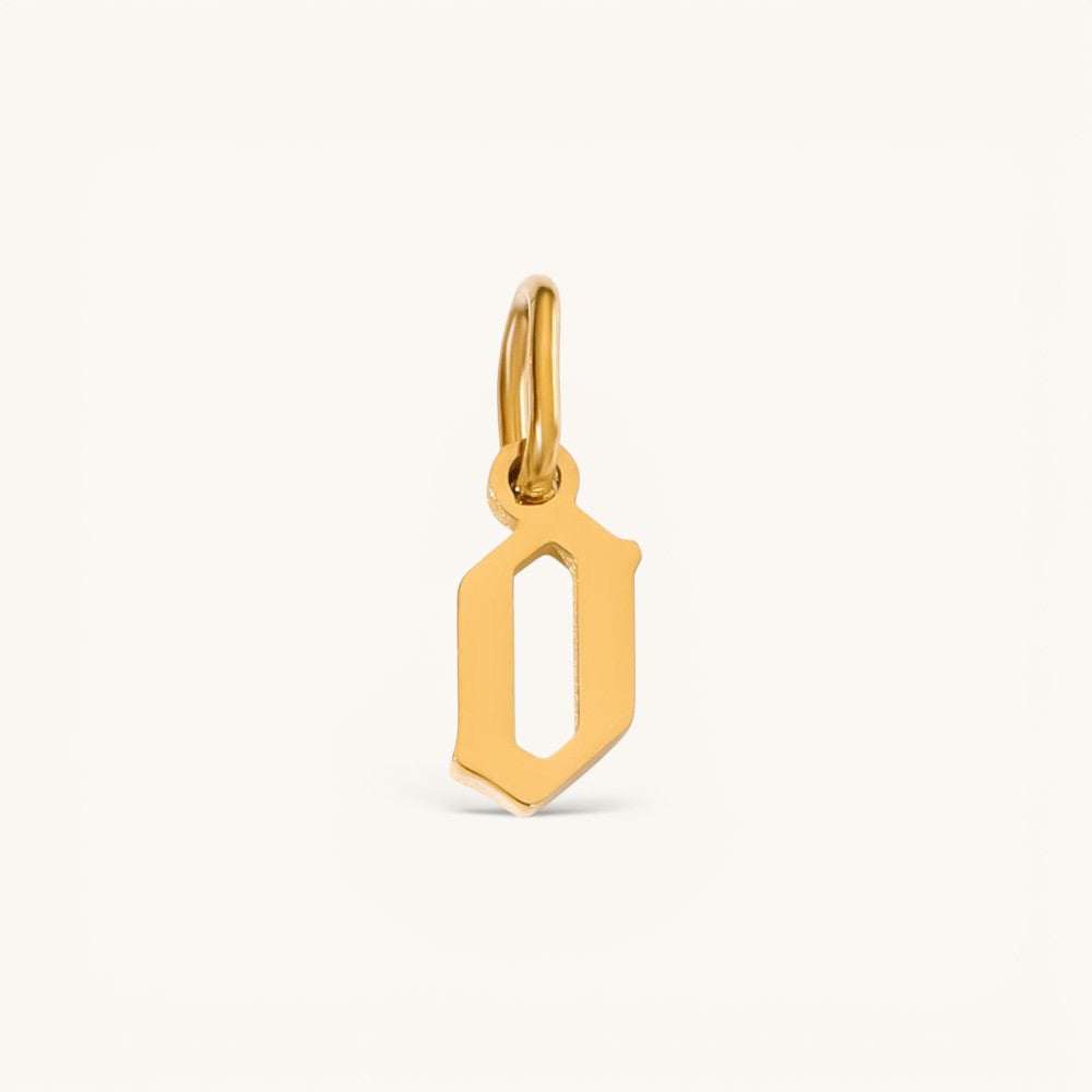 Nadare Co. gold-plated stainless steel gothic letter O charm with sharp edges and a polished finish.