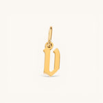 Nadare Co. gold-plated stainless steel gothic letter D charm with sharp edges and old-English style typography.