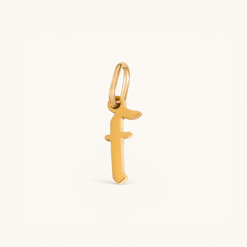 Nadare Co. gold-plated stainless steel gothic letter F charm with sharp edges for a necklace stack.