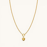 Nadare Co. gold chain necklace featuring a delicate heart charm with a beaded edge on a circular pendant bail.