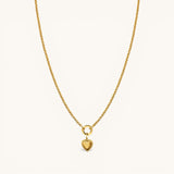 Nadare Co. gold chain necklace featuring a delicate heart charm with a beaded edge on a circular pendant bail.