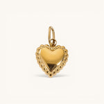 Nadare Co. gold heart charm pendant with a delicate beaded edge detail on a plain background.