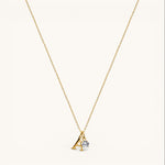 Nadare Co. dainty gold initial necklace with a letter A pendant and a sparkling round birthstone charm.