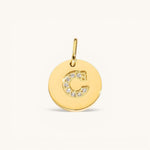 Nadare Co. gold initial charm with pavé set diamonds on a polished disc, letter C.