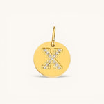 Nadare Co. gold initial charm with pavé set crystals forming the letter X on a polished disc.