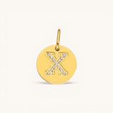 Nadare Co. gold initial charm with pavé set crystals forming the letter X on a polished disc.