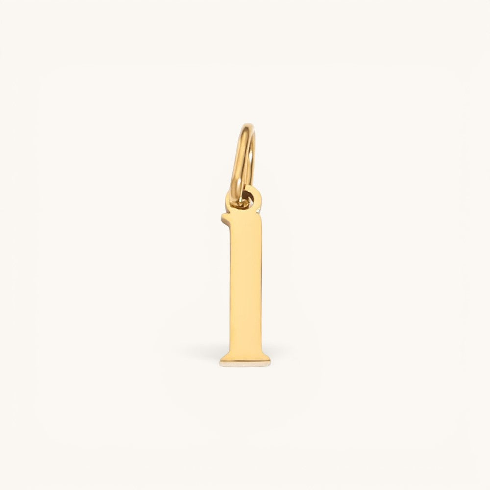 Nadare Co. lower case letter I charm in 14k gold plated stainless steel for everyday jewelry layering